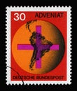 Stamp printed in Germany showing Cross in front of a globe with map of South America